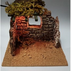 Small terracotta hut with...